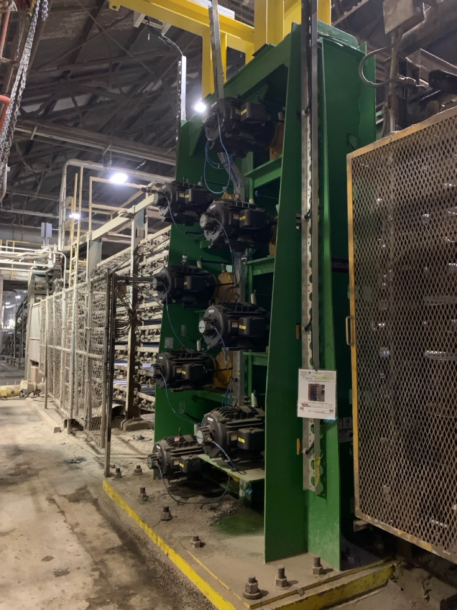 The completed drive system installed on the dryer, showing the motor assembly on the plant floor